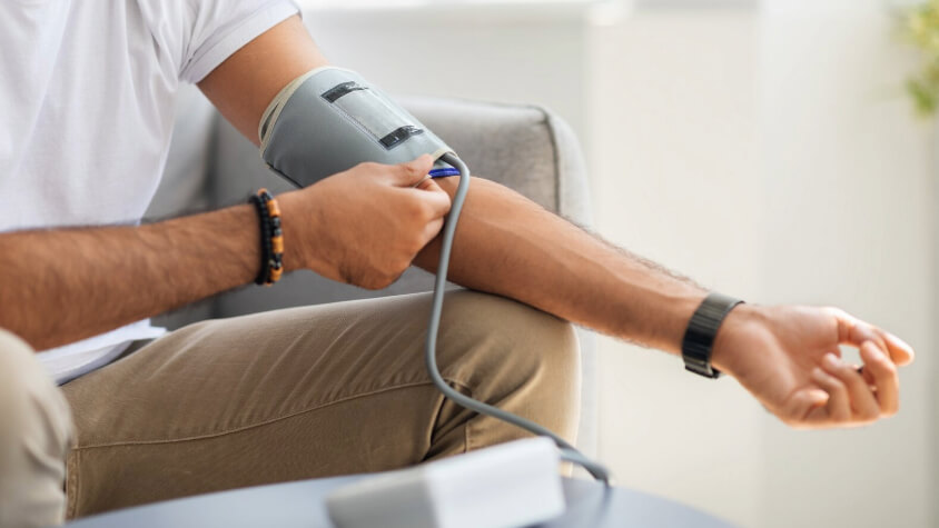 A man using a blood pressure monitor