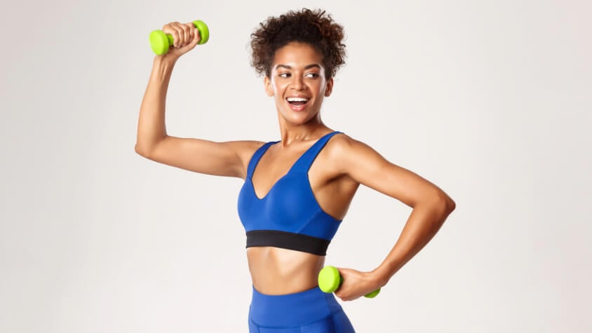 A woman holding dumbbells