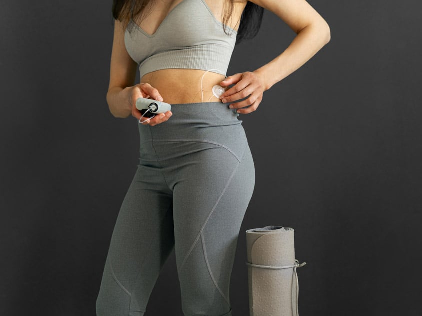A girl with an insulin pump standing