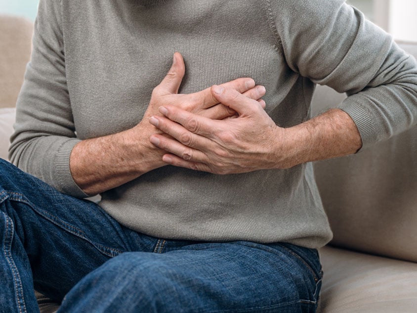 A man puts his hands on his chest