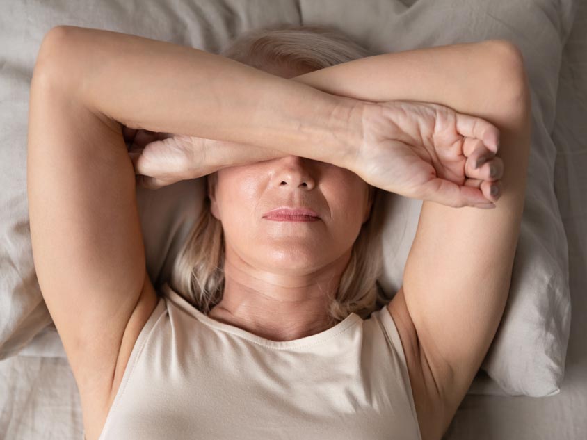 A woman puts her arms over her head