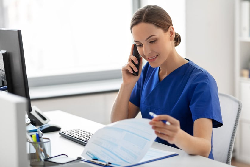 A health professional using a telephone