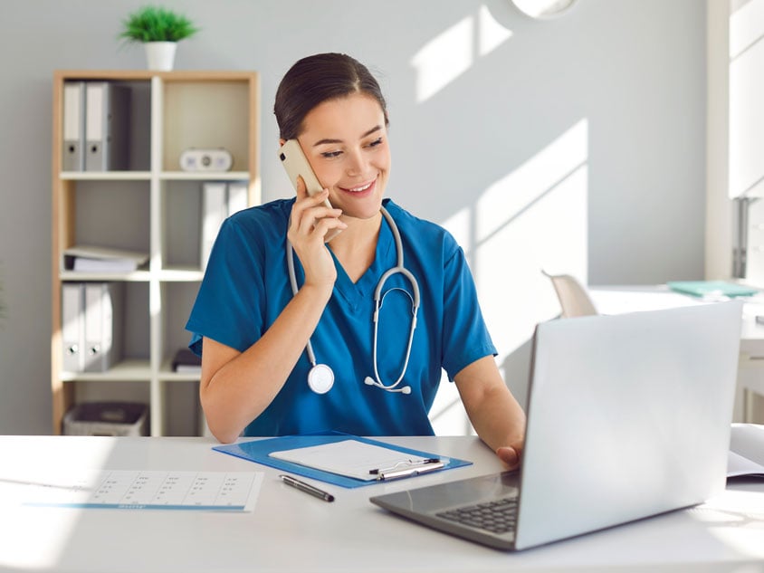 A health professional using a telephone
