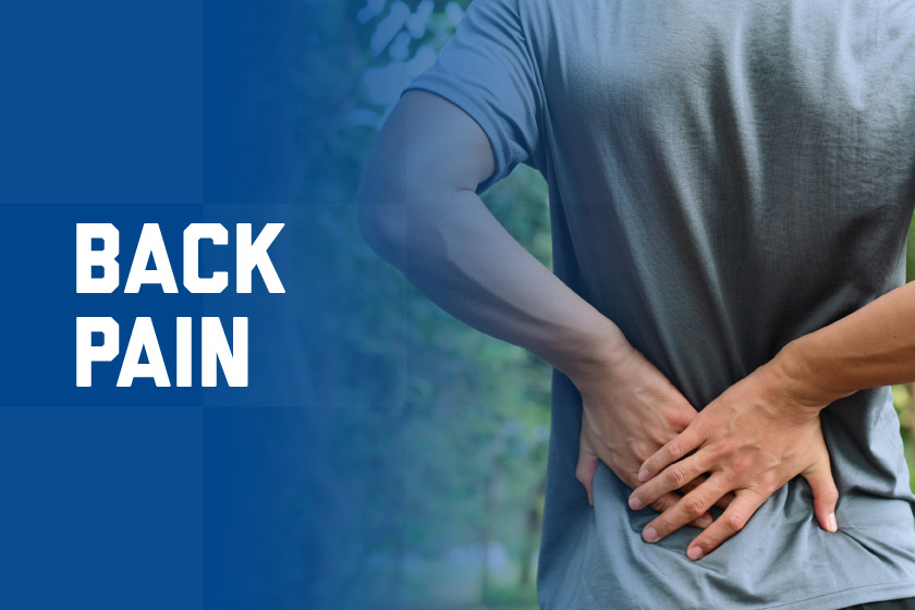 A man holds his back in pain