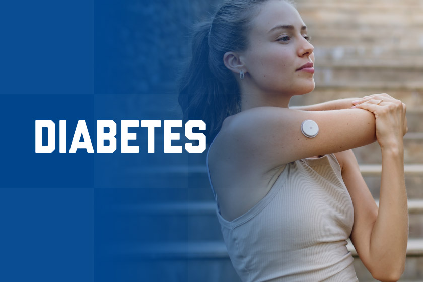 A young woman exercising with a glucose monitor on her arm