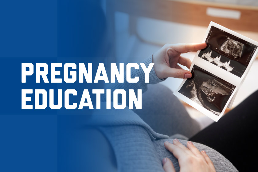 Pregnant woman holding ultrasound pictures