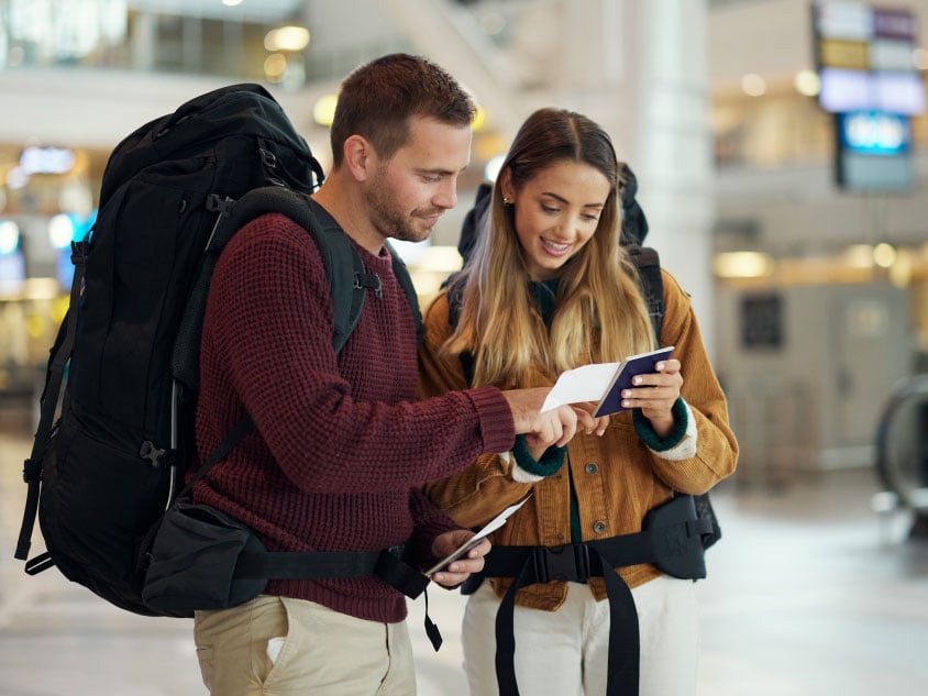 A couple standing at the airport
