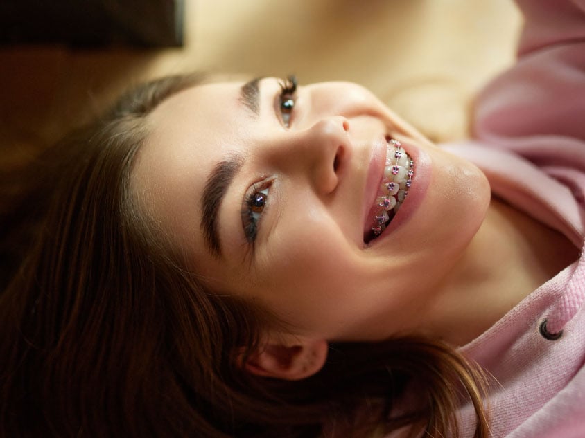 A girl with braces smiling