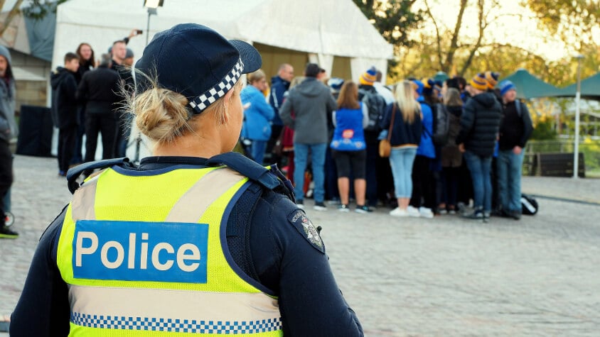 A police officer standing near a crowd