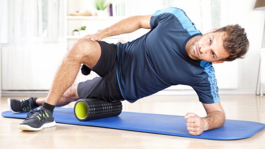 A man using a foam roller
