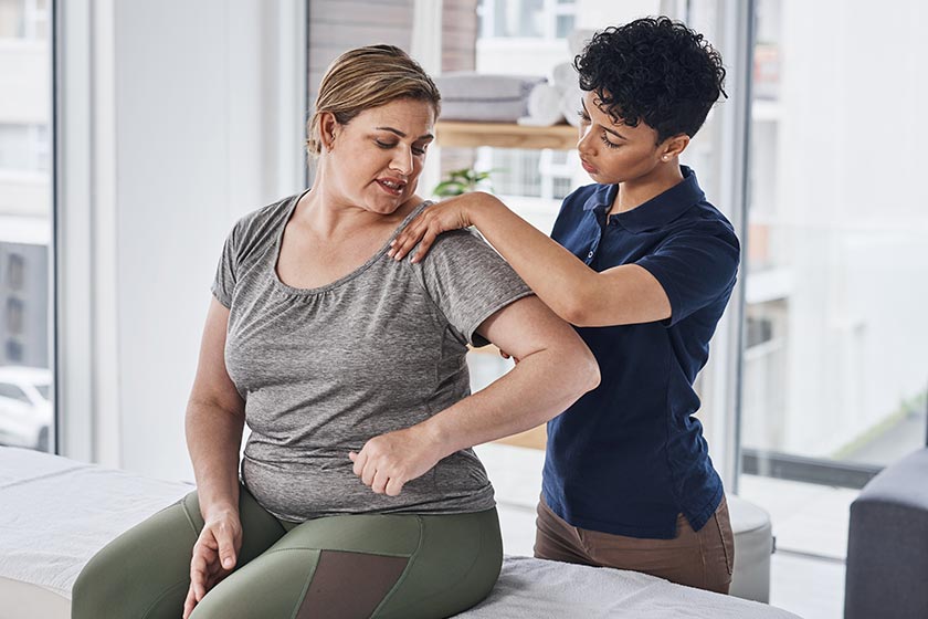 A physio treats a woman